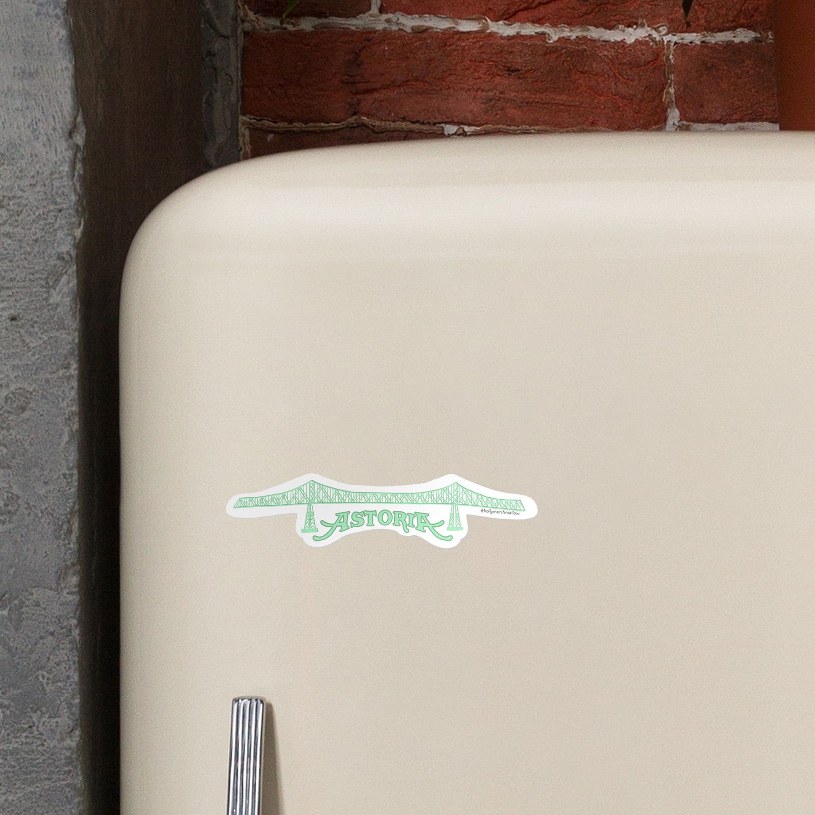 Mockup of a retro tan fridge door with the Megler Bridge magnet on it