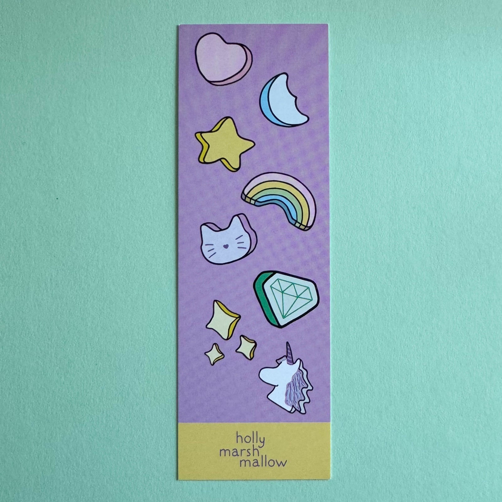 Purple bookmark with colorful illustrations on a teal background