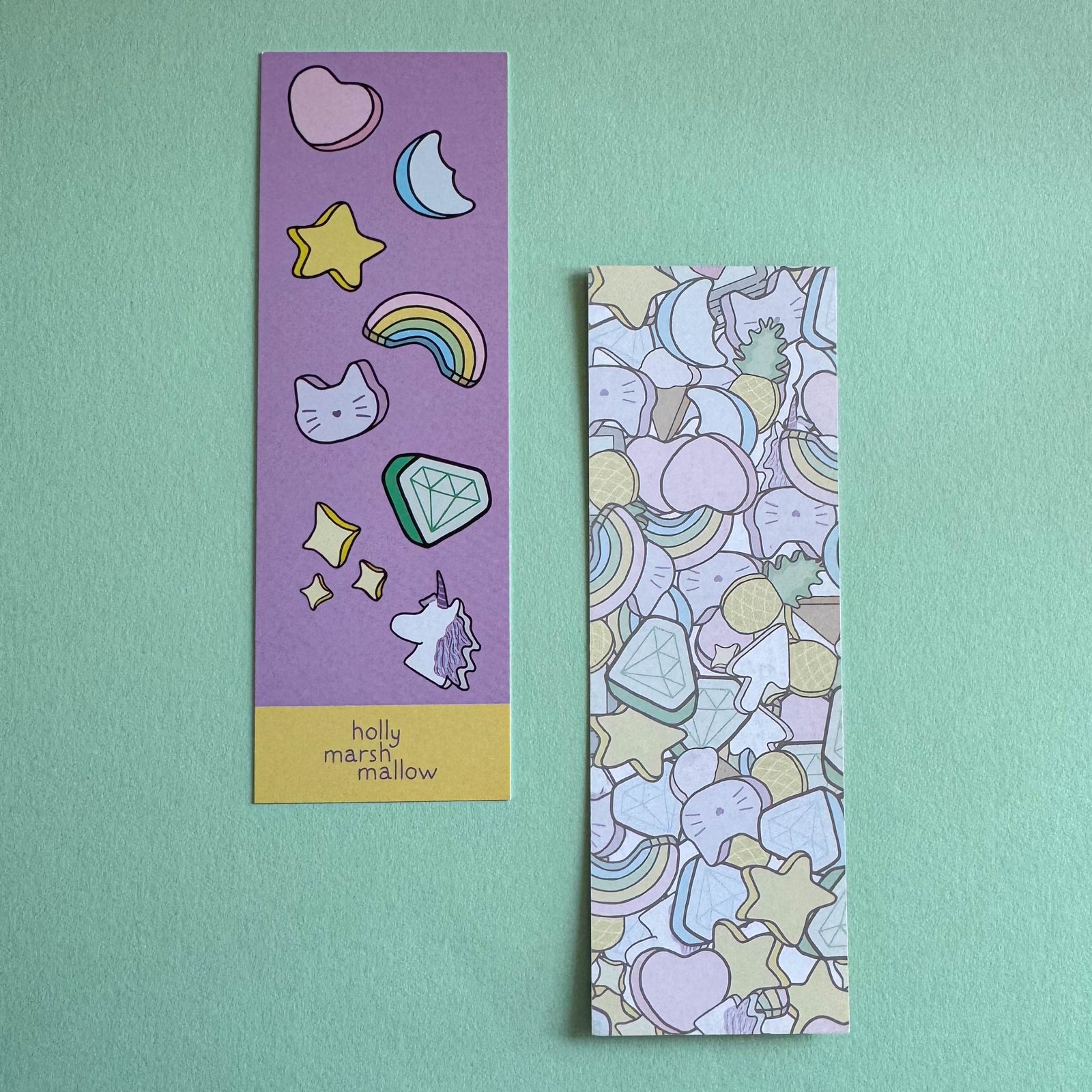 Two colorful bookmarks with illustrations on a light green background