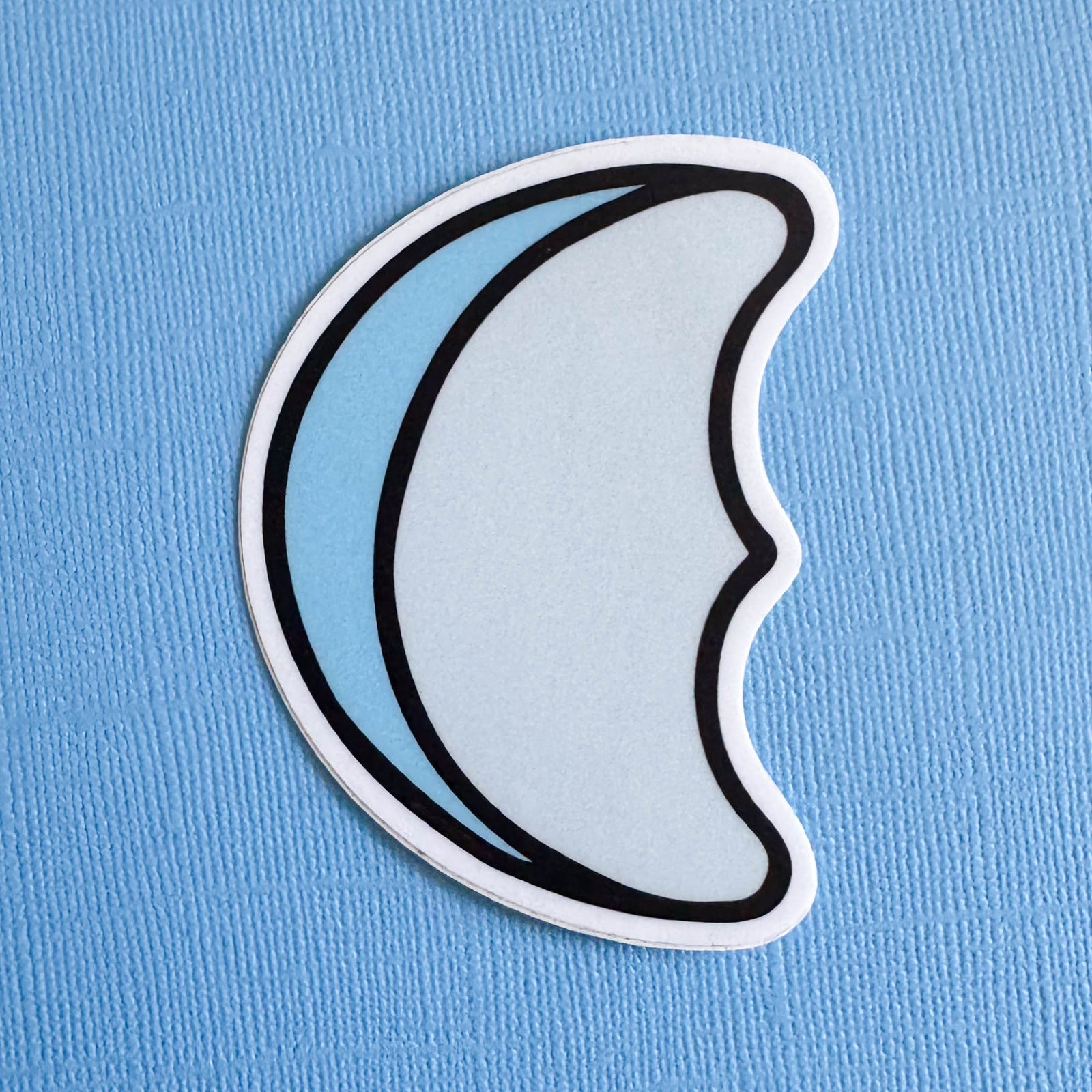 Sticker of a half moon marshmallow on a blue background