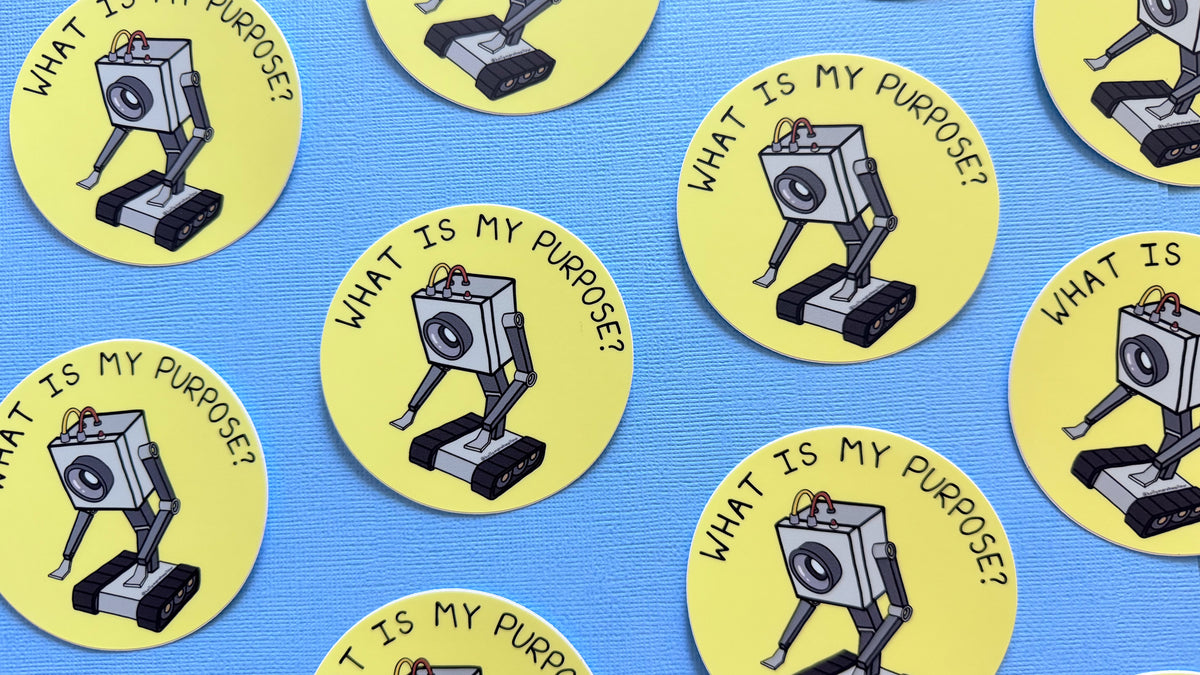 Multiple Yellow circle stickers with the Butter Robot from Rick + Morty in the center with hand-lettered text that reads What is My Purpose? on a blue background