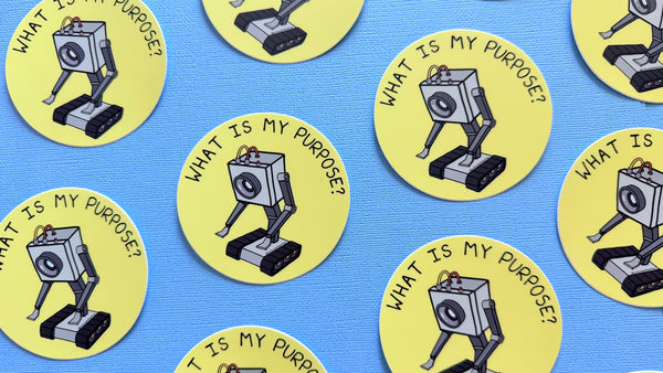 Multiple Yellow circle stickers with the Butter Robot from Rick + Morty in the center with hand-lettered text that reads What is My Purpose? on a blue background