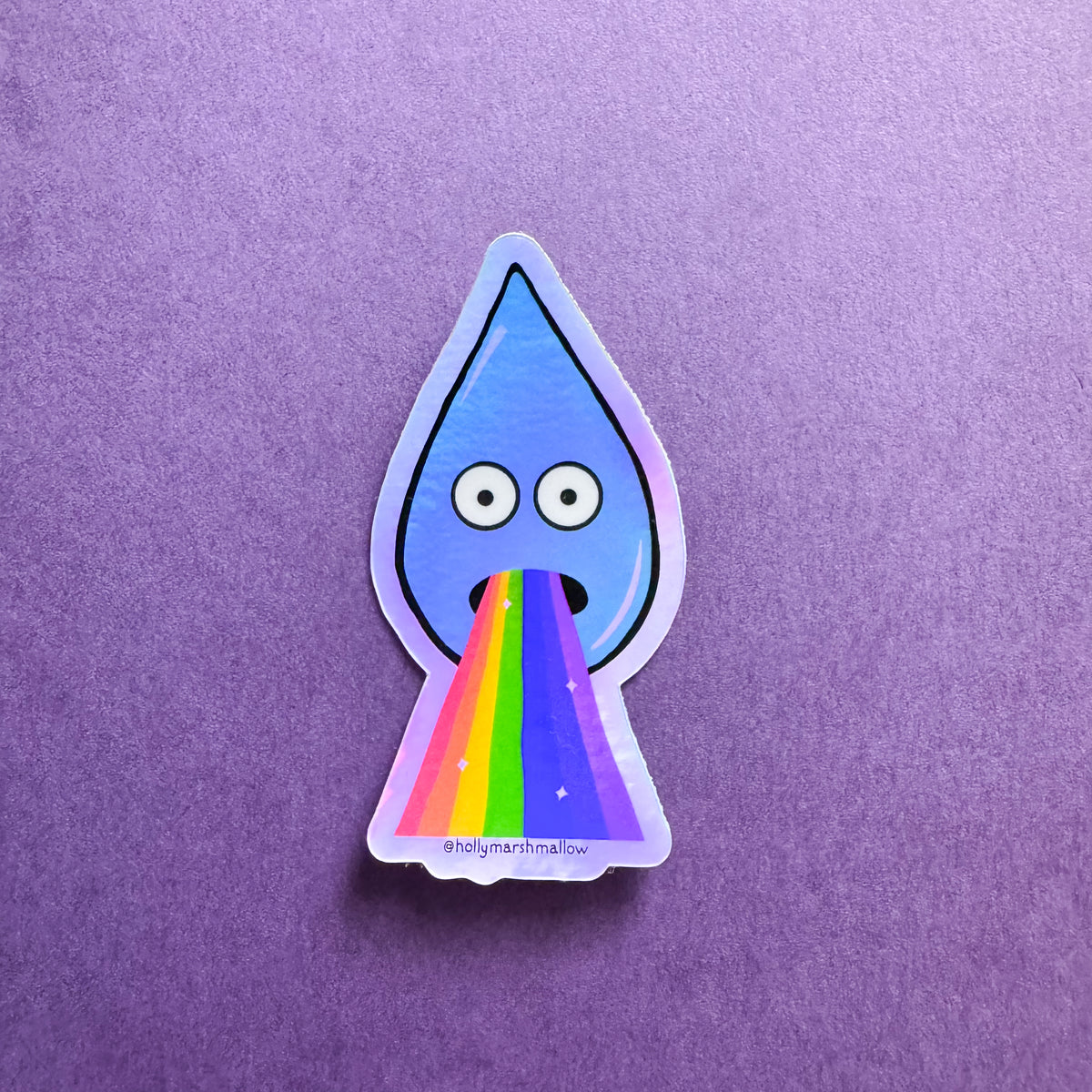 Sticker of a blue droplet with eyes barfing a rainbow on a purple background