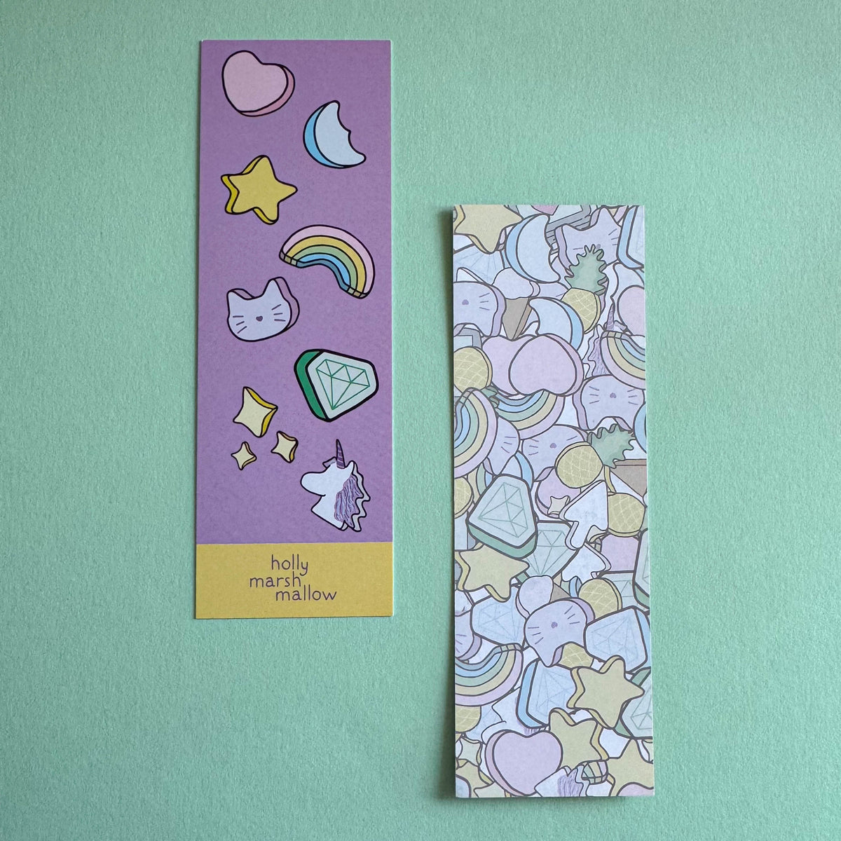 Two colorful bookmarks with illustrations on a light green background