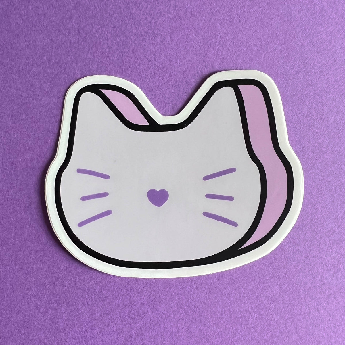 Sticker of a marshmallow cat on a purple background