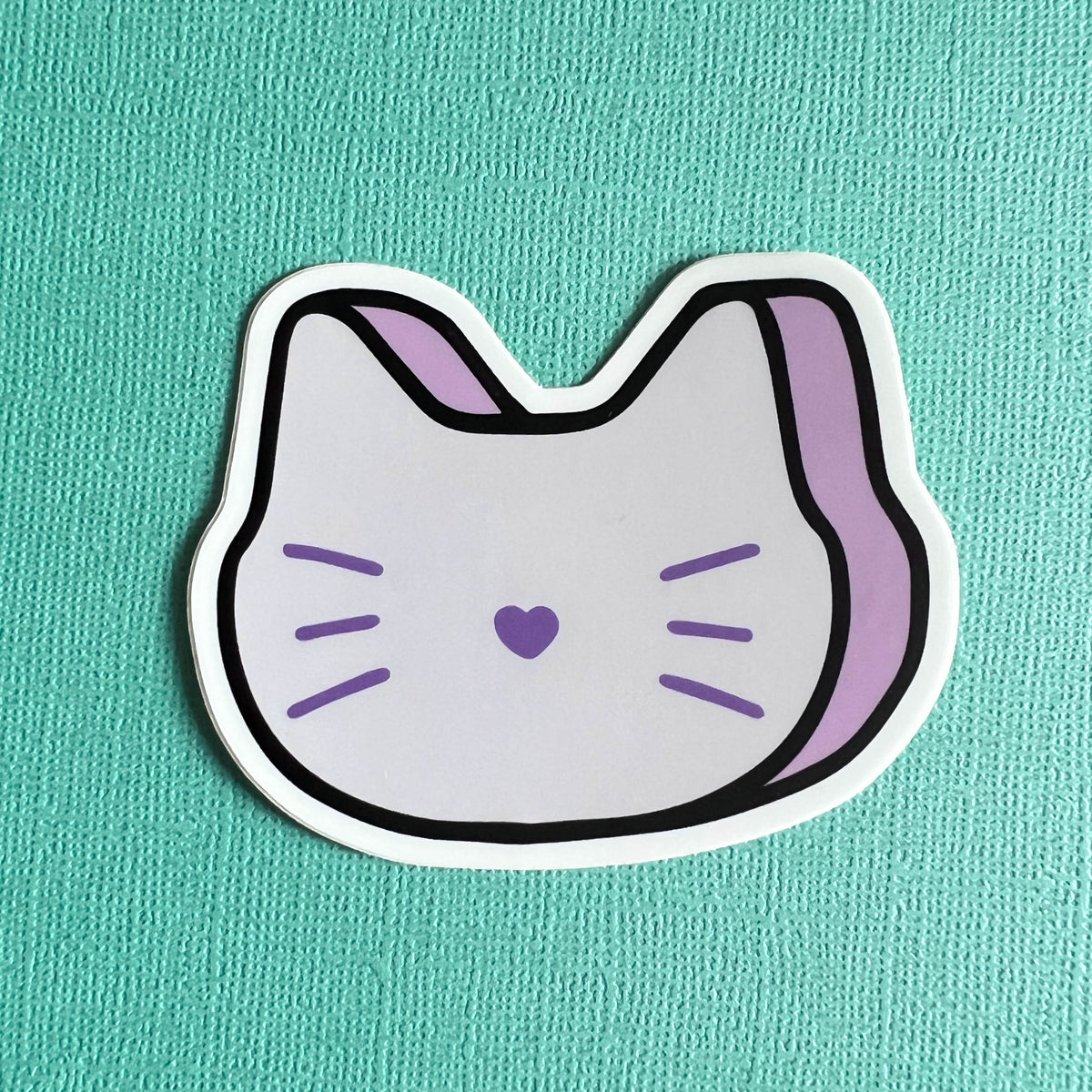 Sticker of a purple marshmallow cat on a teal background