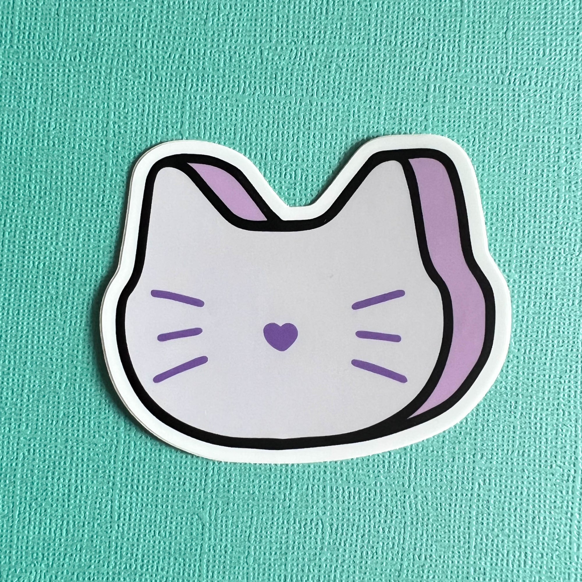 Sticker of a purple marshmallow cat on a teal background