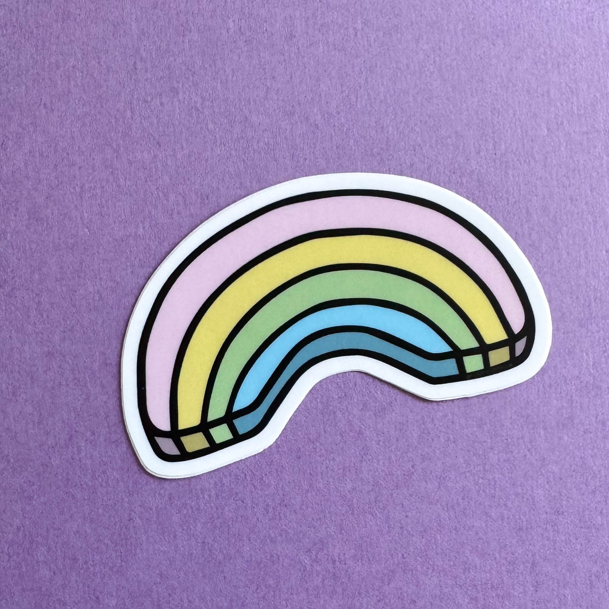 Colorful rainbow sticker on a purple background