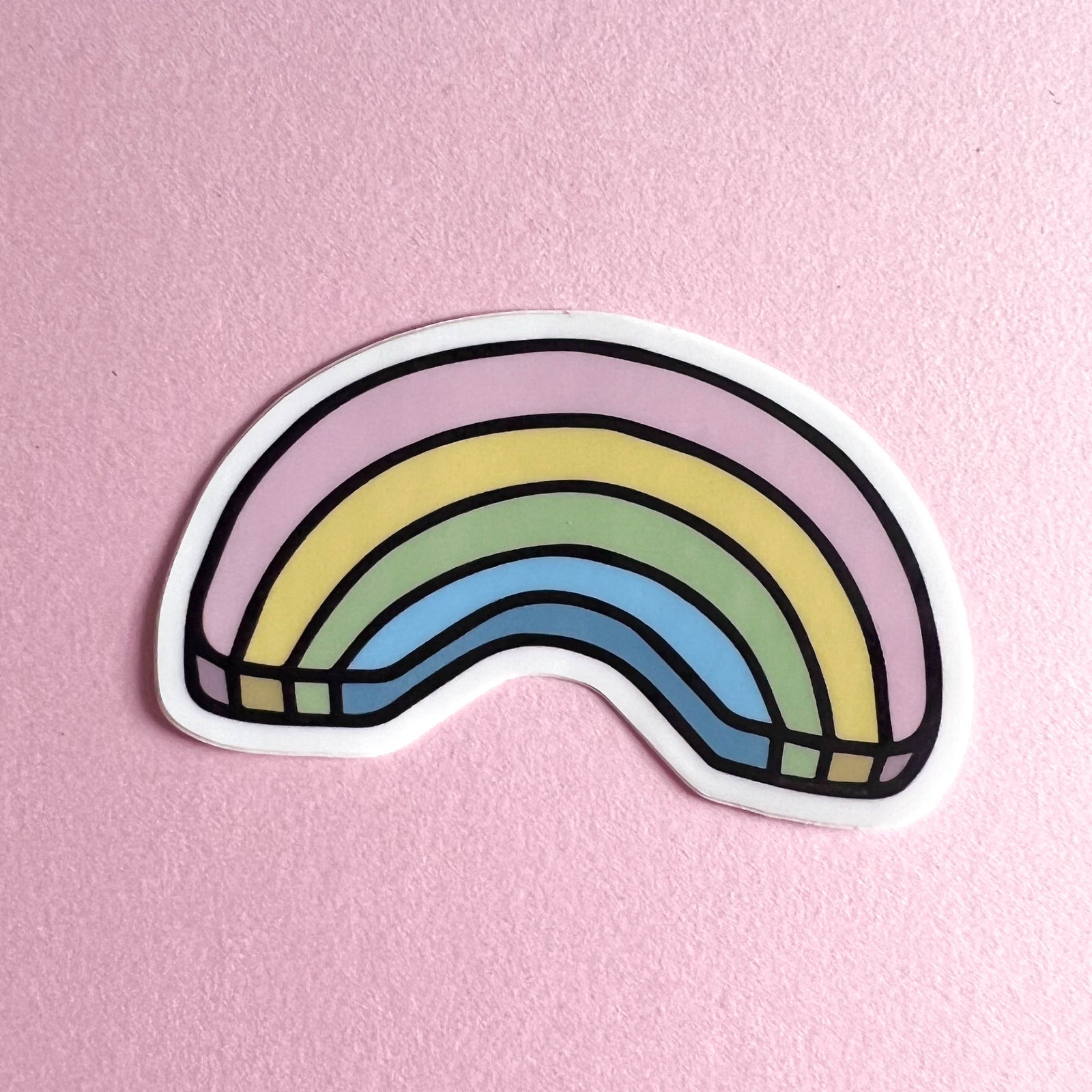 Colorful rainbow sticker on a pink background