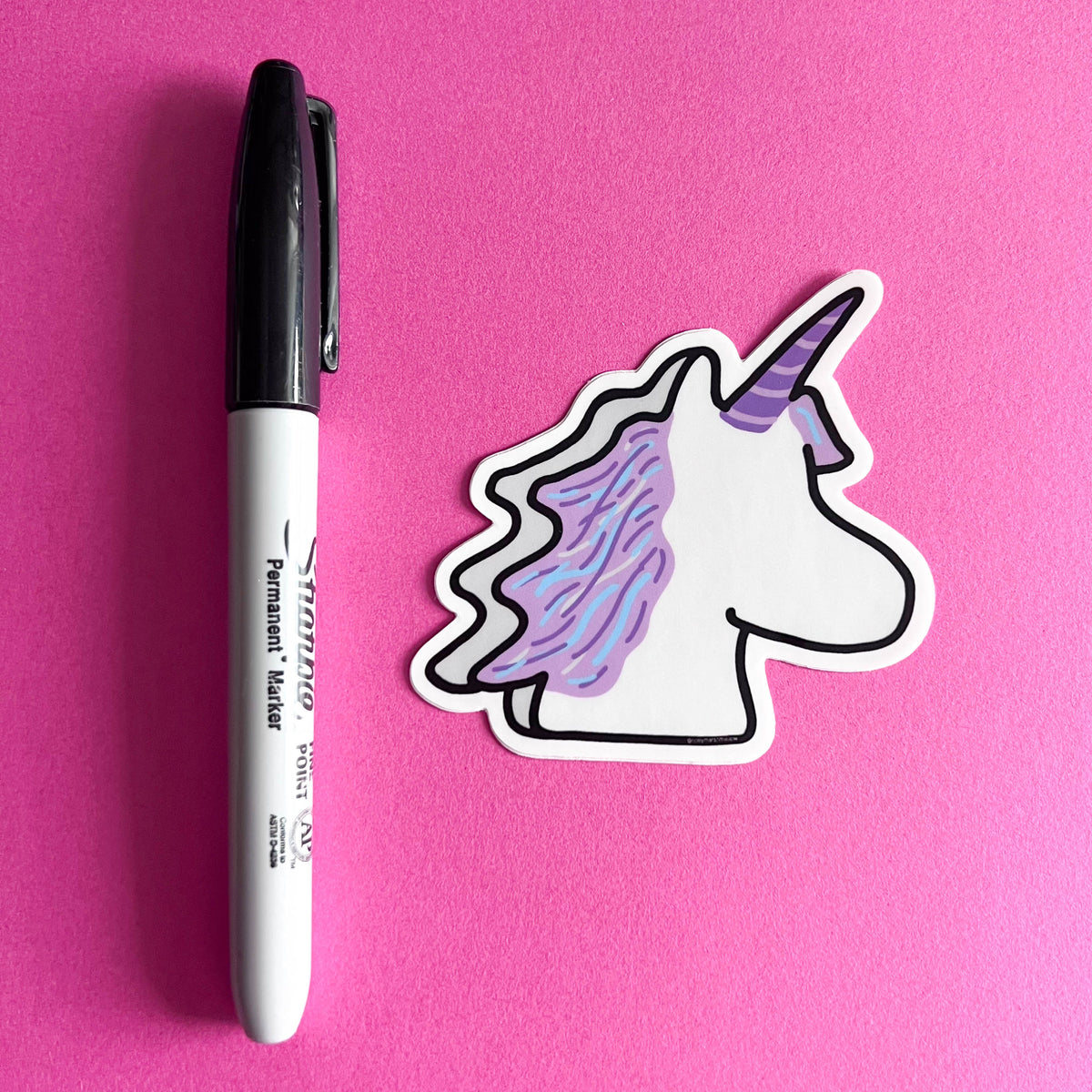 Unicorn sticker and marker on a pink background
