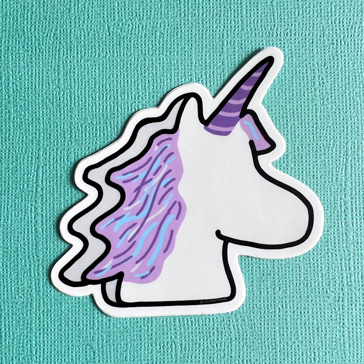 Marshmallow Unicorn sticker with a purple mane on a teal background