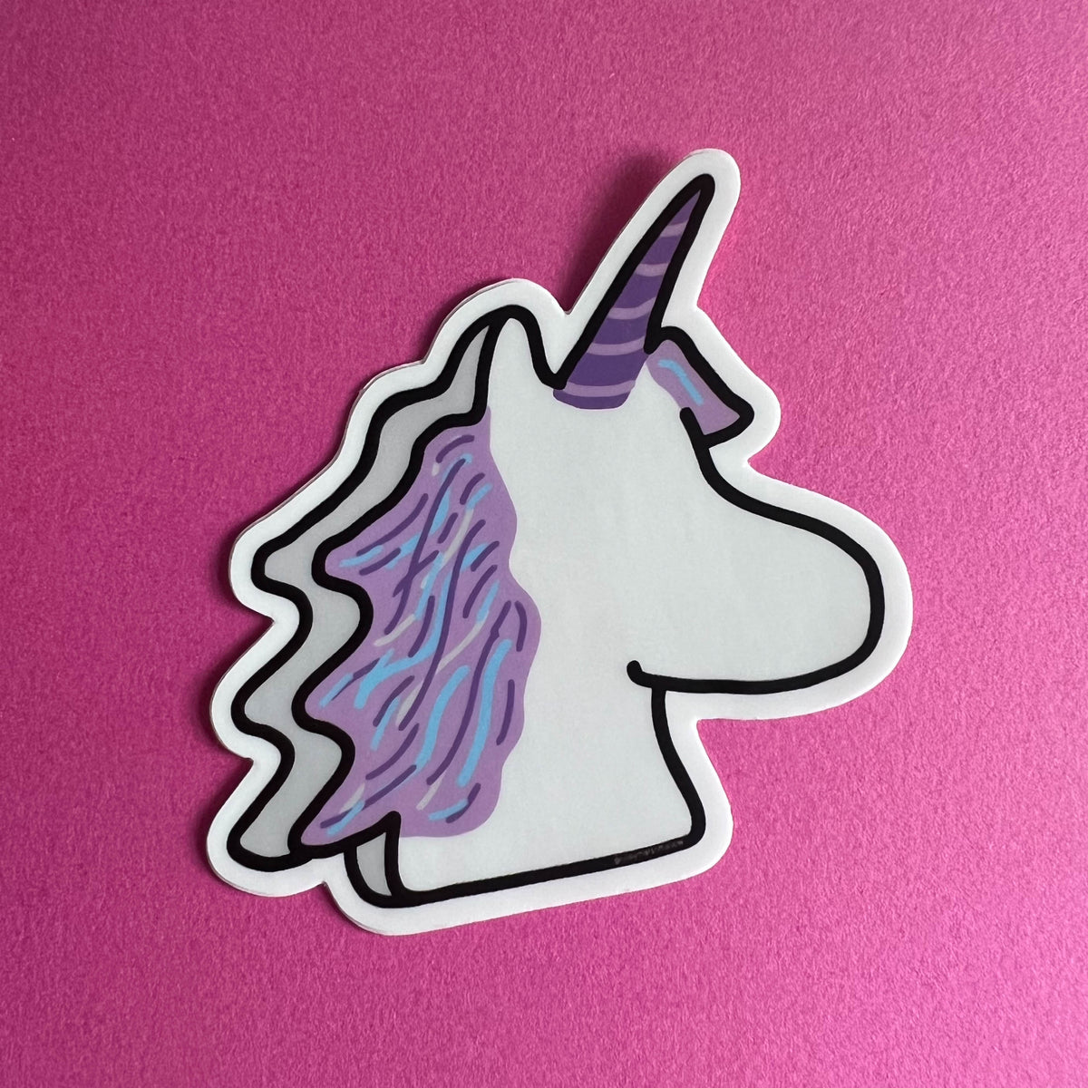 Marshmallow Unicorn sticker with a purple horn on a pink background