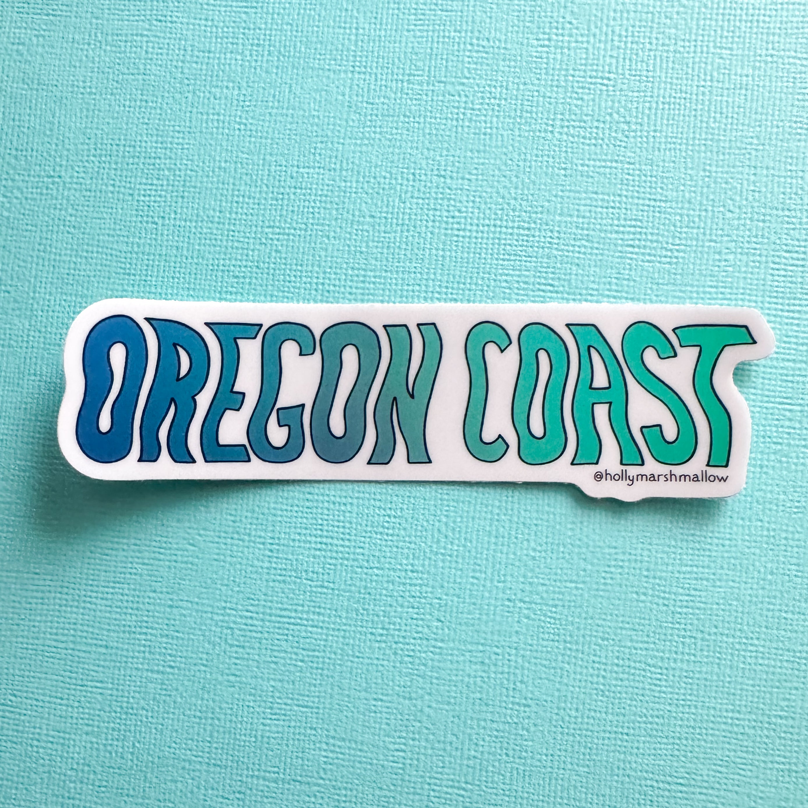 Sticker with hand-lettered 'OREGON COAST' text on a teal background