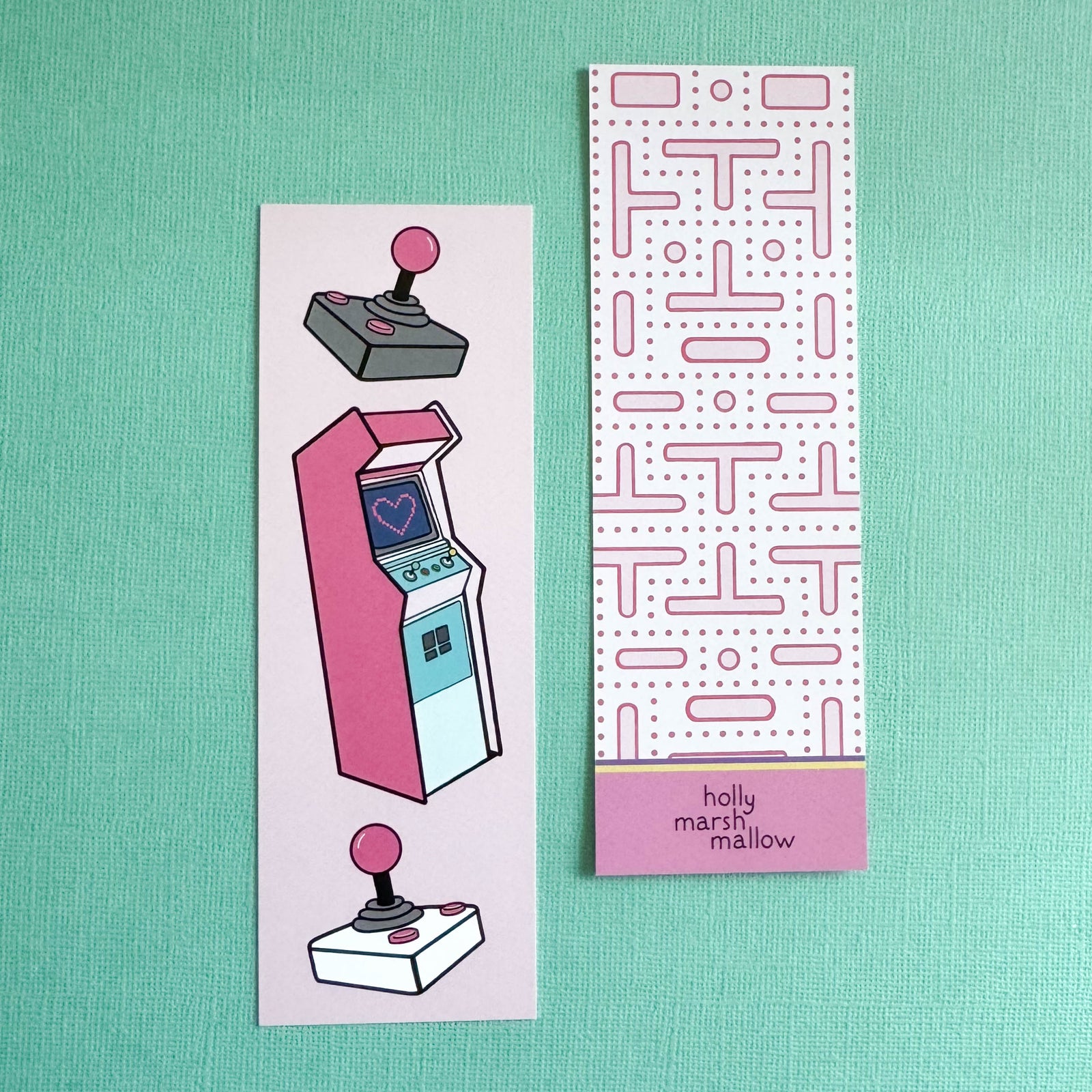 Two bookmarks with arcade design and pattern on a teal background