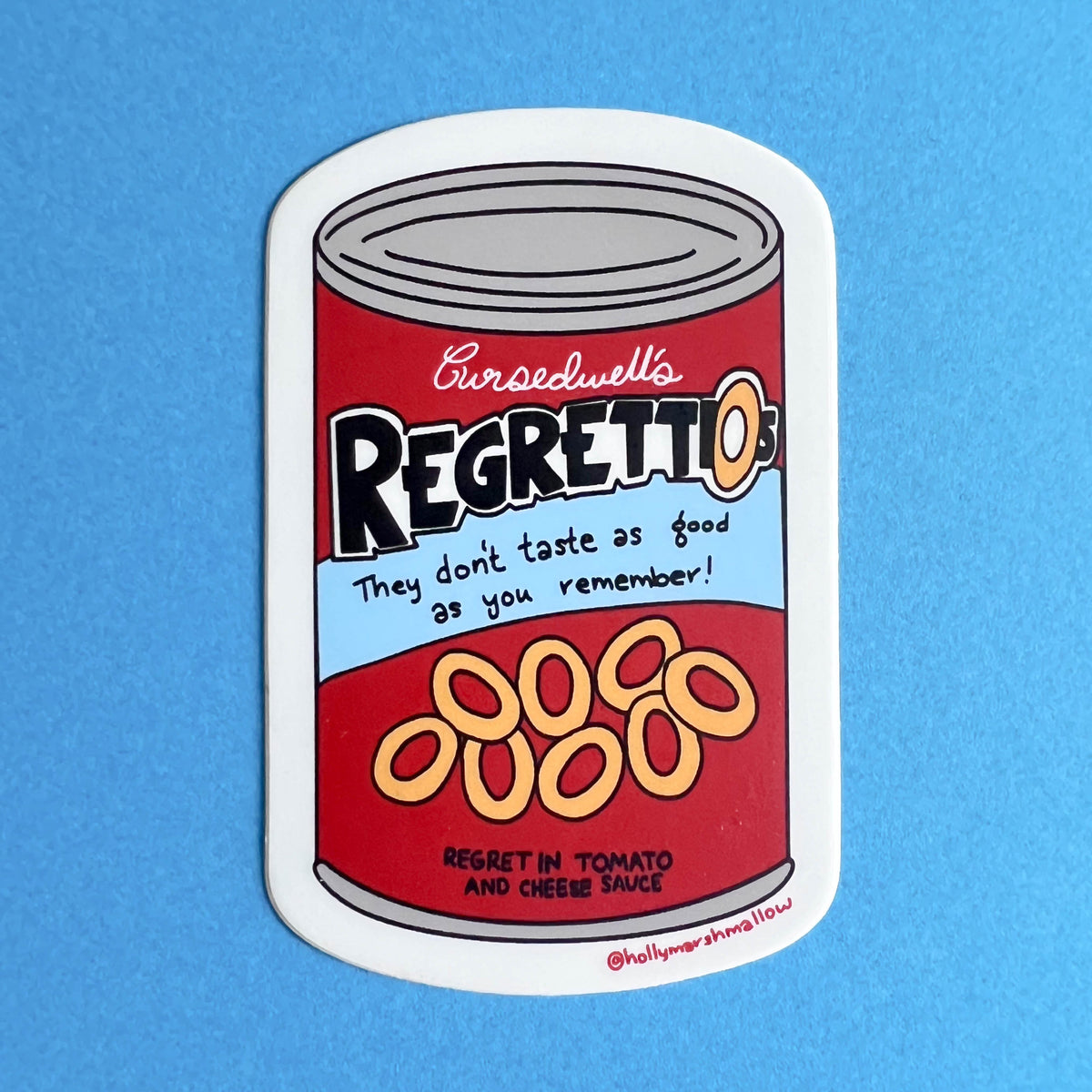 Sticker of a can labeled &#39;Cursedwell&#39;s Regrettios&#39; on a blue background