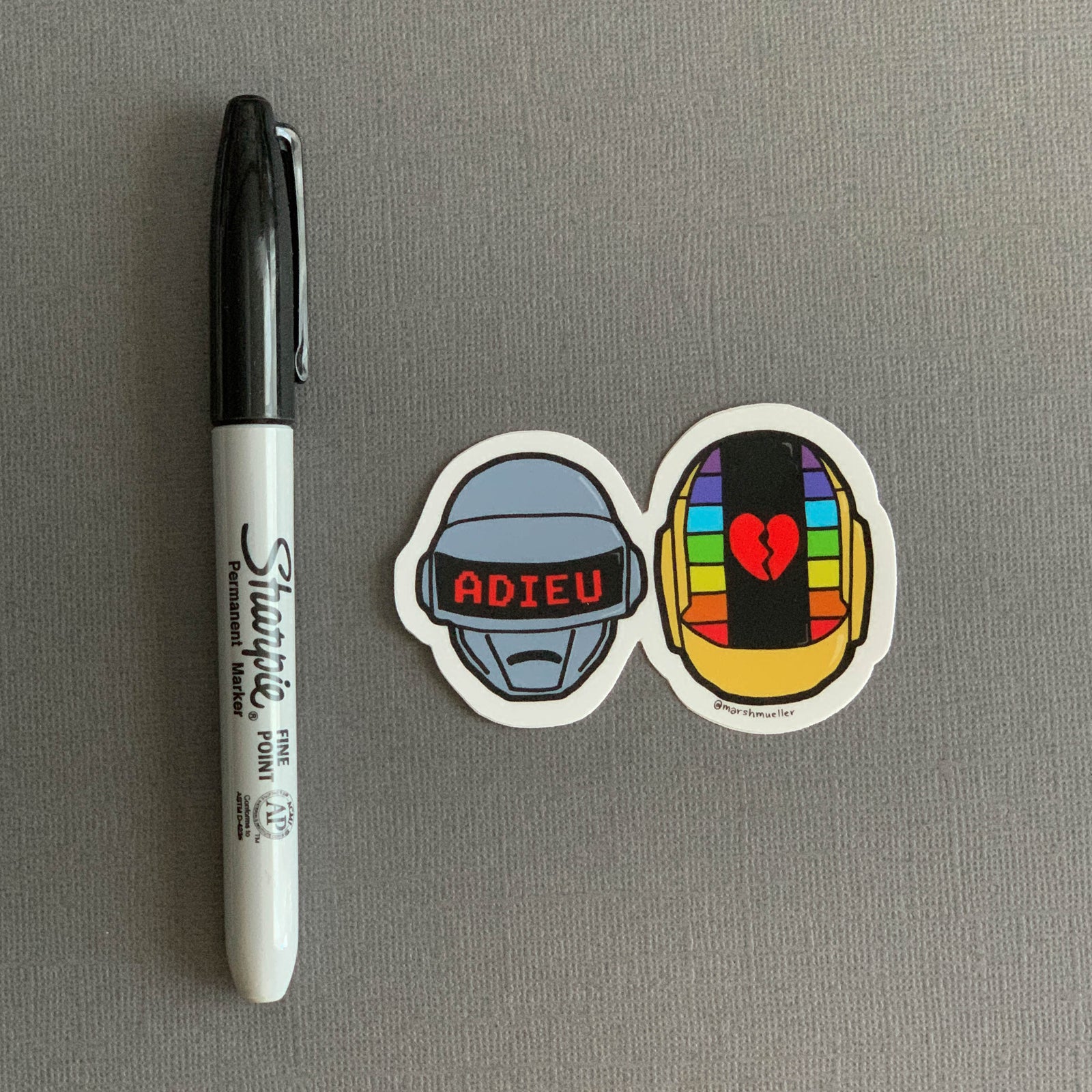 Daft Punk Die Cut Sticker next to a black Sharpie for scale on a grey background
